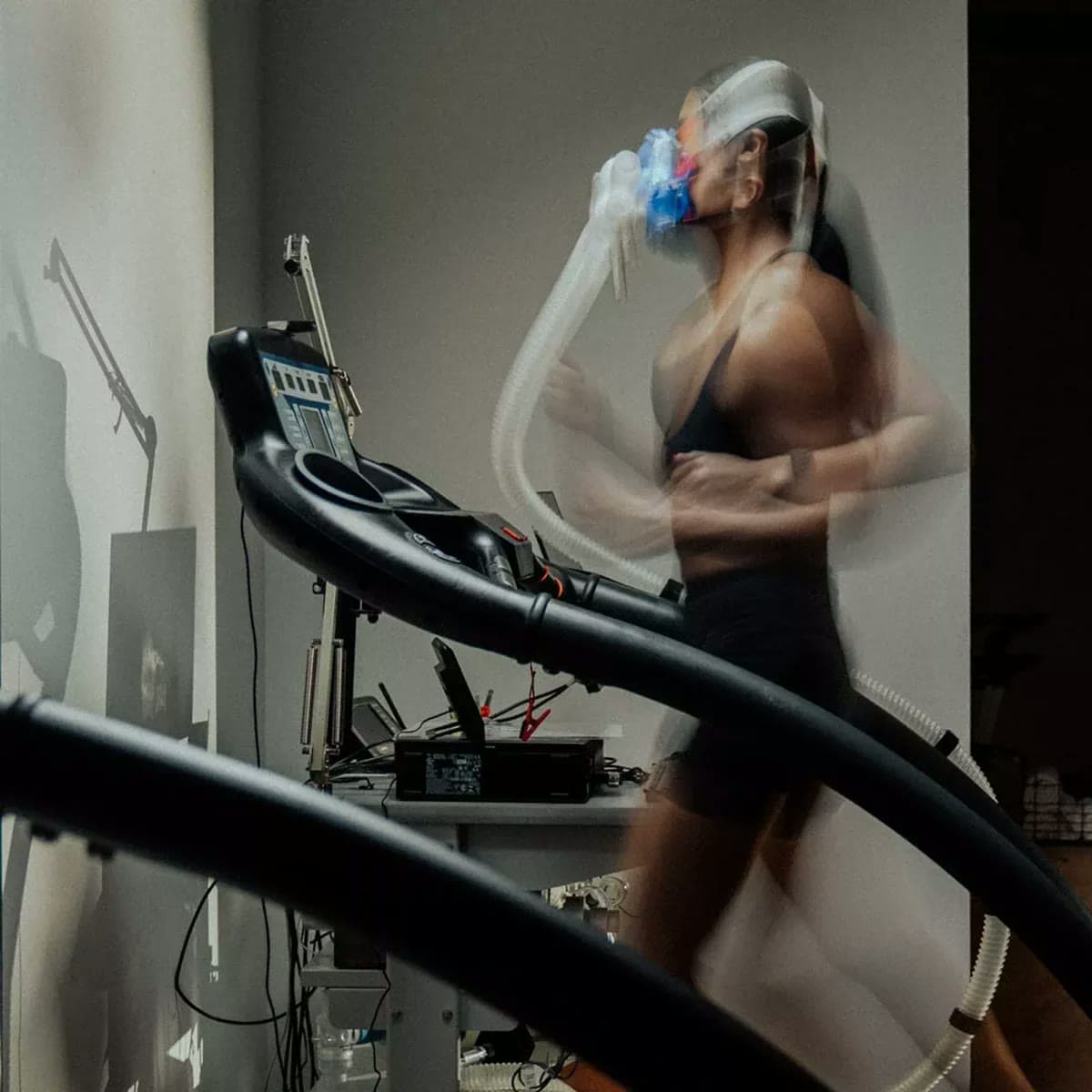 Running on a treadmill while breathing through an oxygen mask